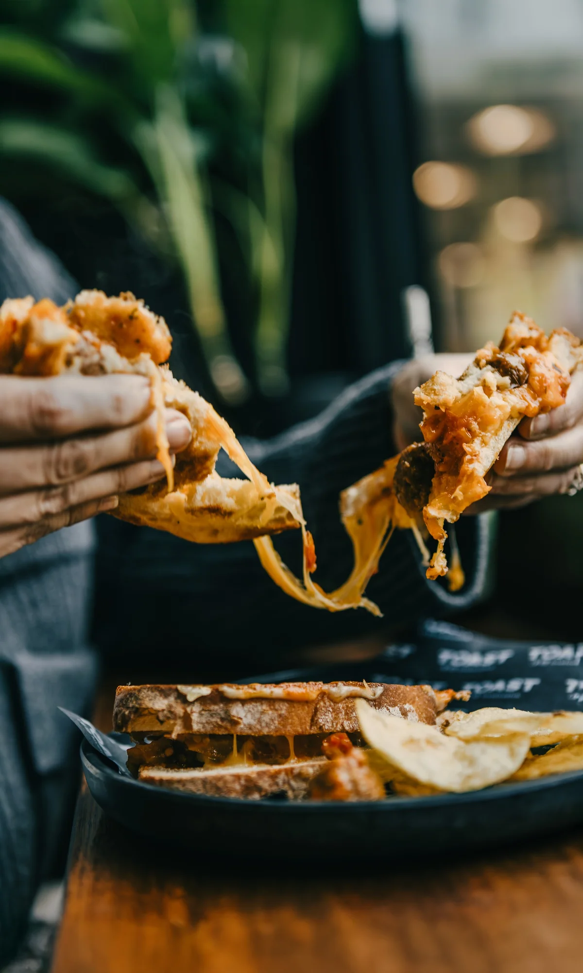 A Toast Toasties cheese toastie pulled apart, molten cheese stretching between the halves